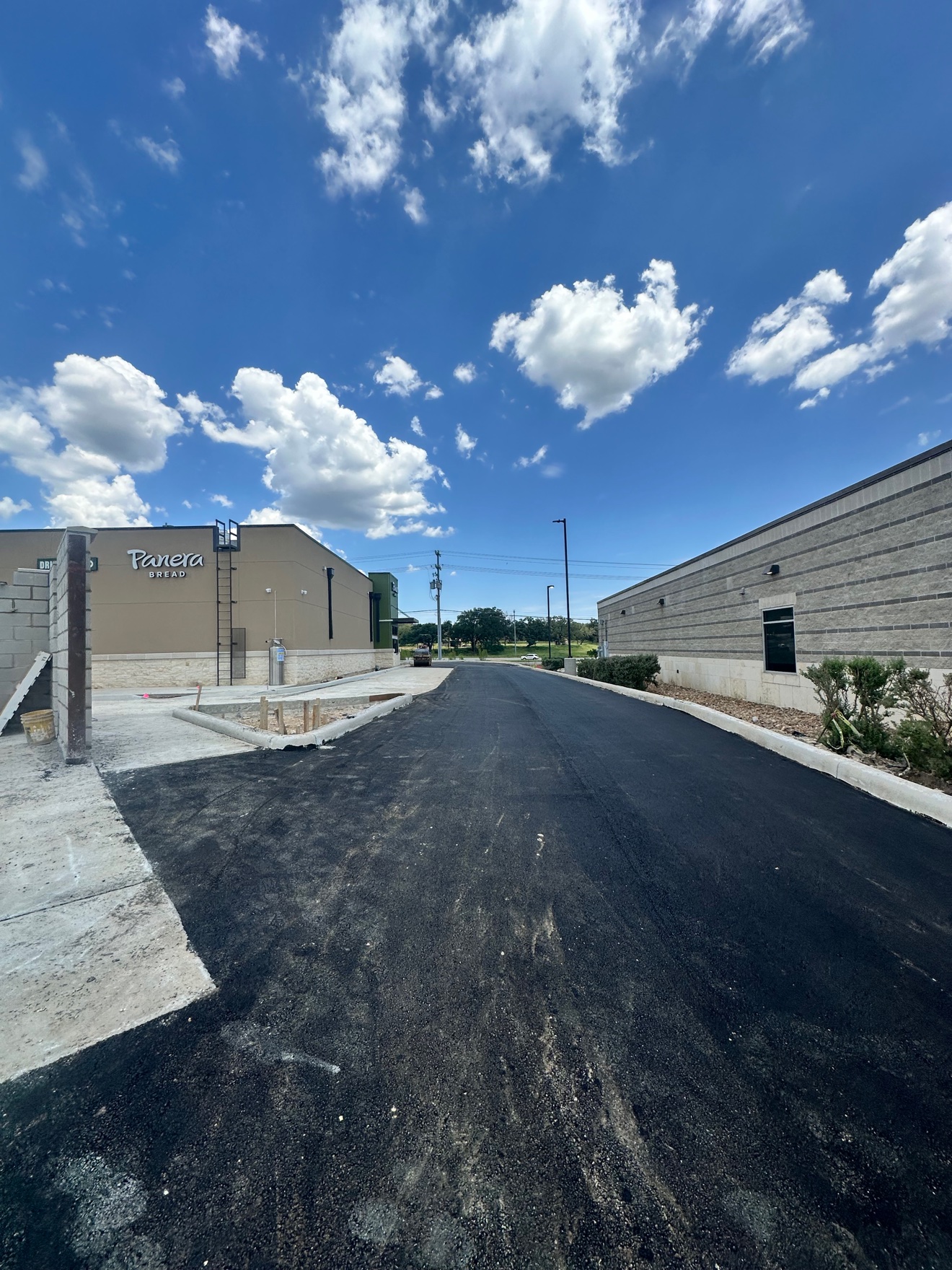 Fresh asphalt parking lot lane beside Panera Bread