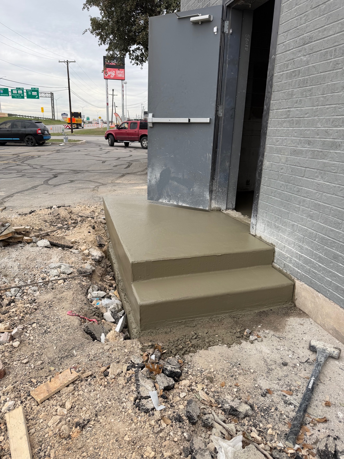 Fresh concrete steps and landing at a commercial building entrance