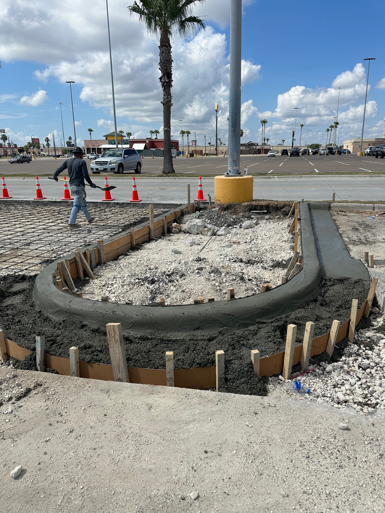 Concrete curb island poured at a parking lot entrance