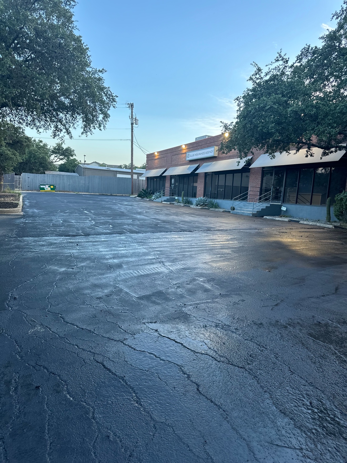 Freshly sealcoated parking lot in front of an office building