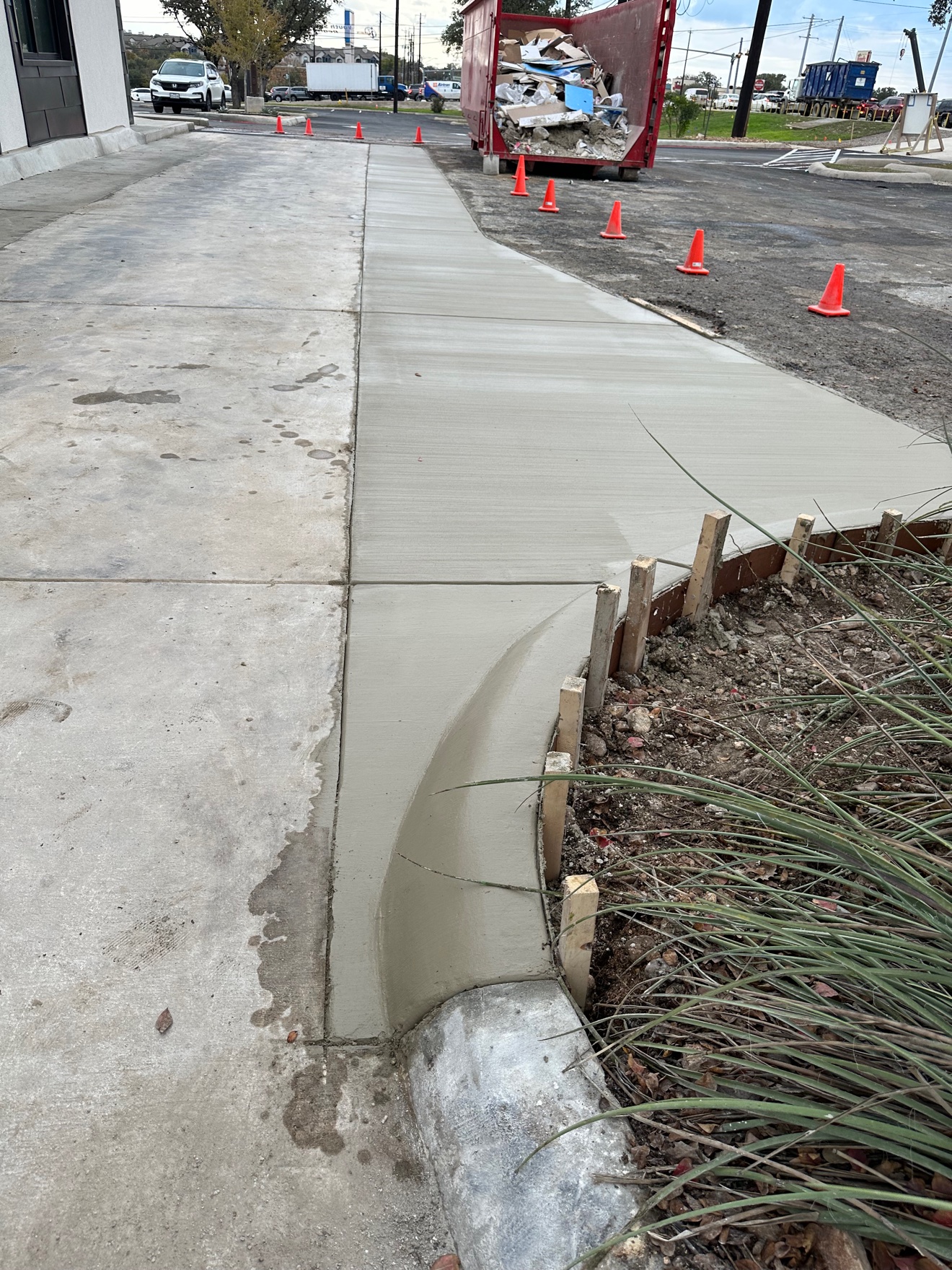 Fresh concrete pour with a rolled curb taking shape on the first job