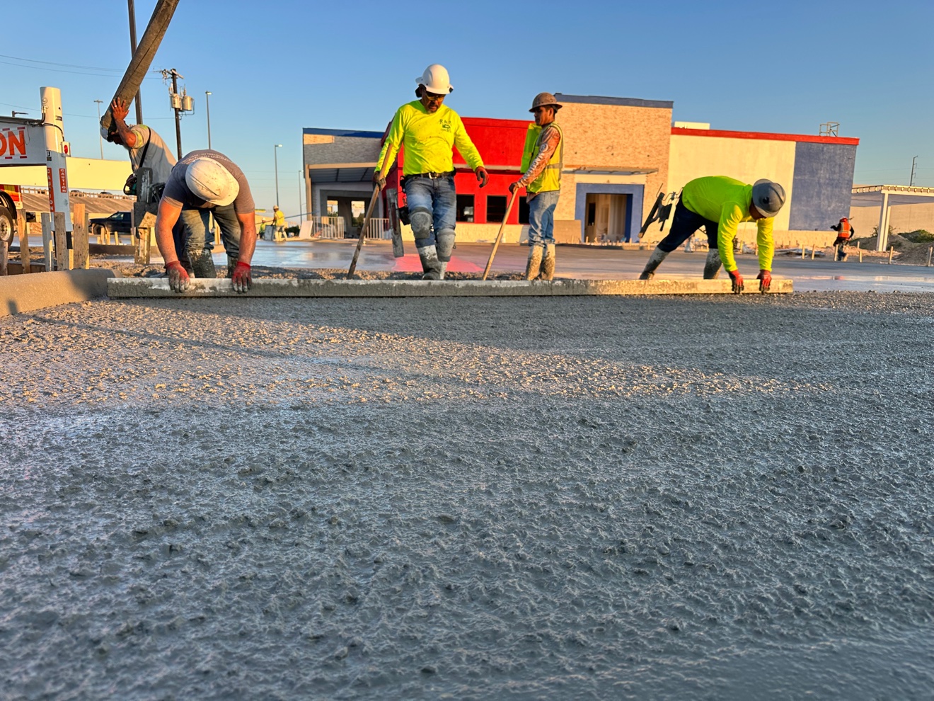 Crew screeding a fresh concrete pour