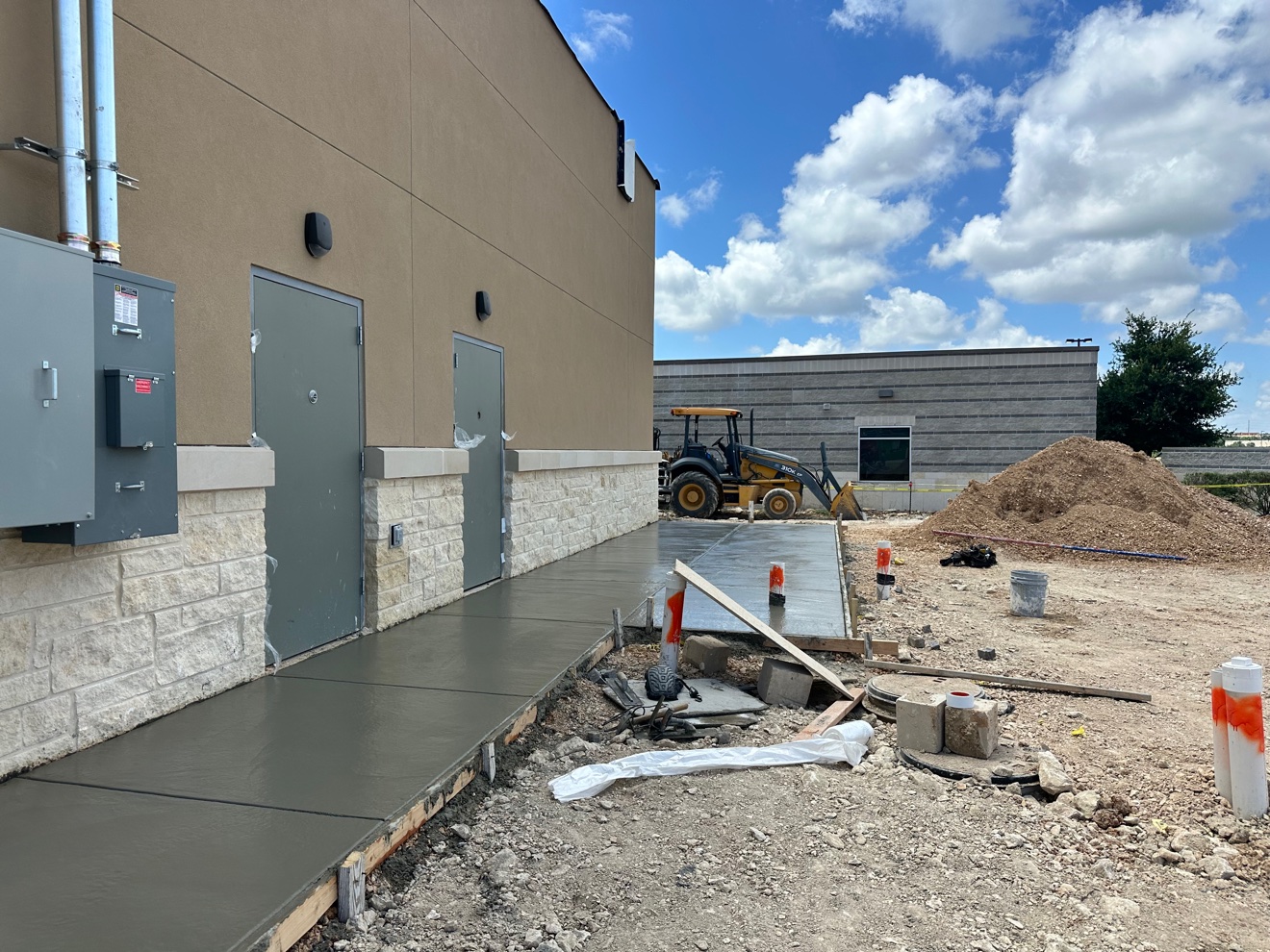 Freshly poured concrete sidewalk along the side of Panera Bread