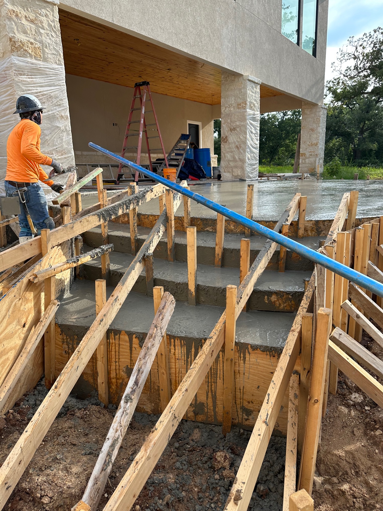 Concrete steps in wood formwork during the pour at a stone house