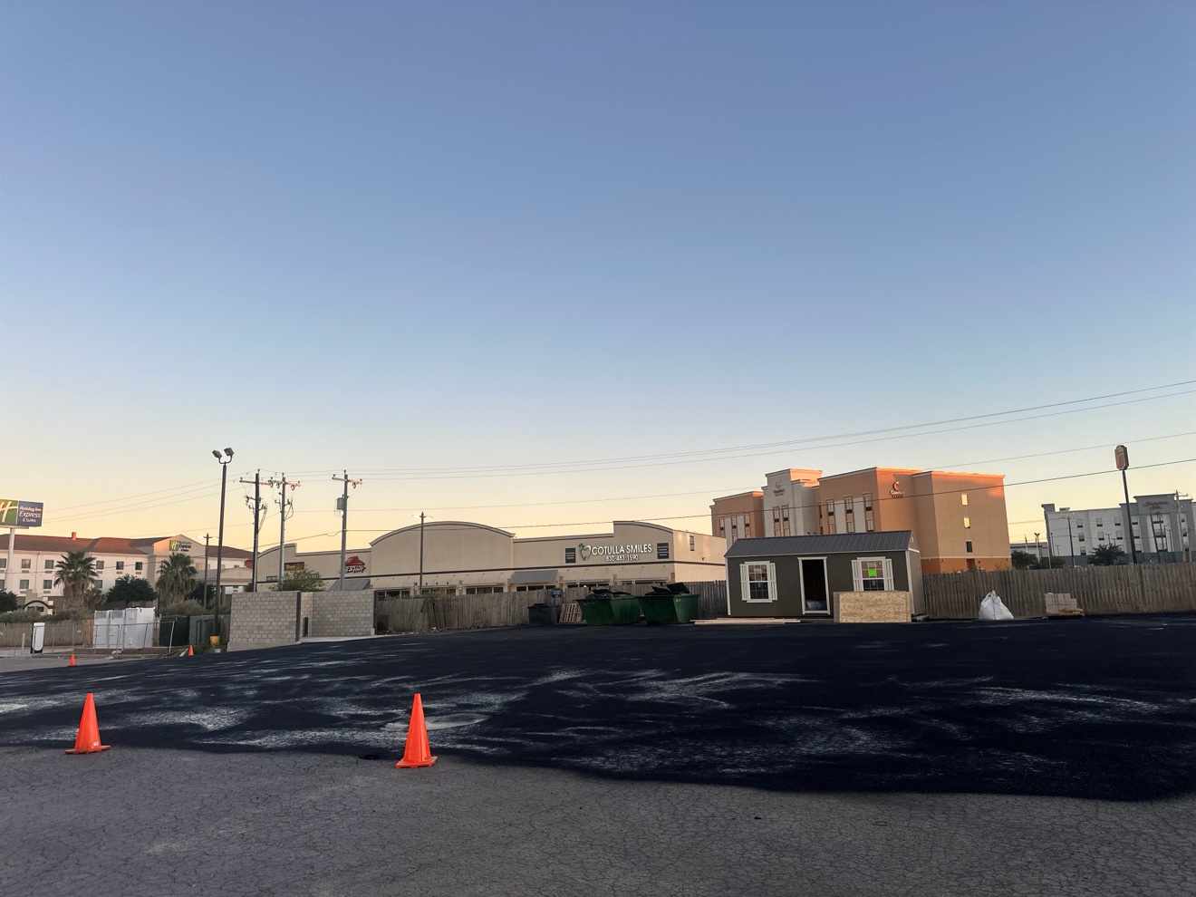 Fresh asphalt coating on a parking lot at dusk