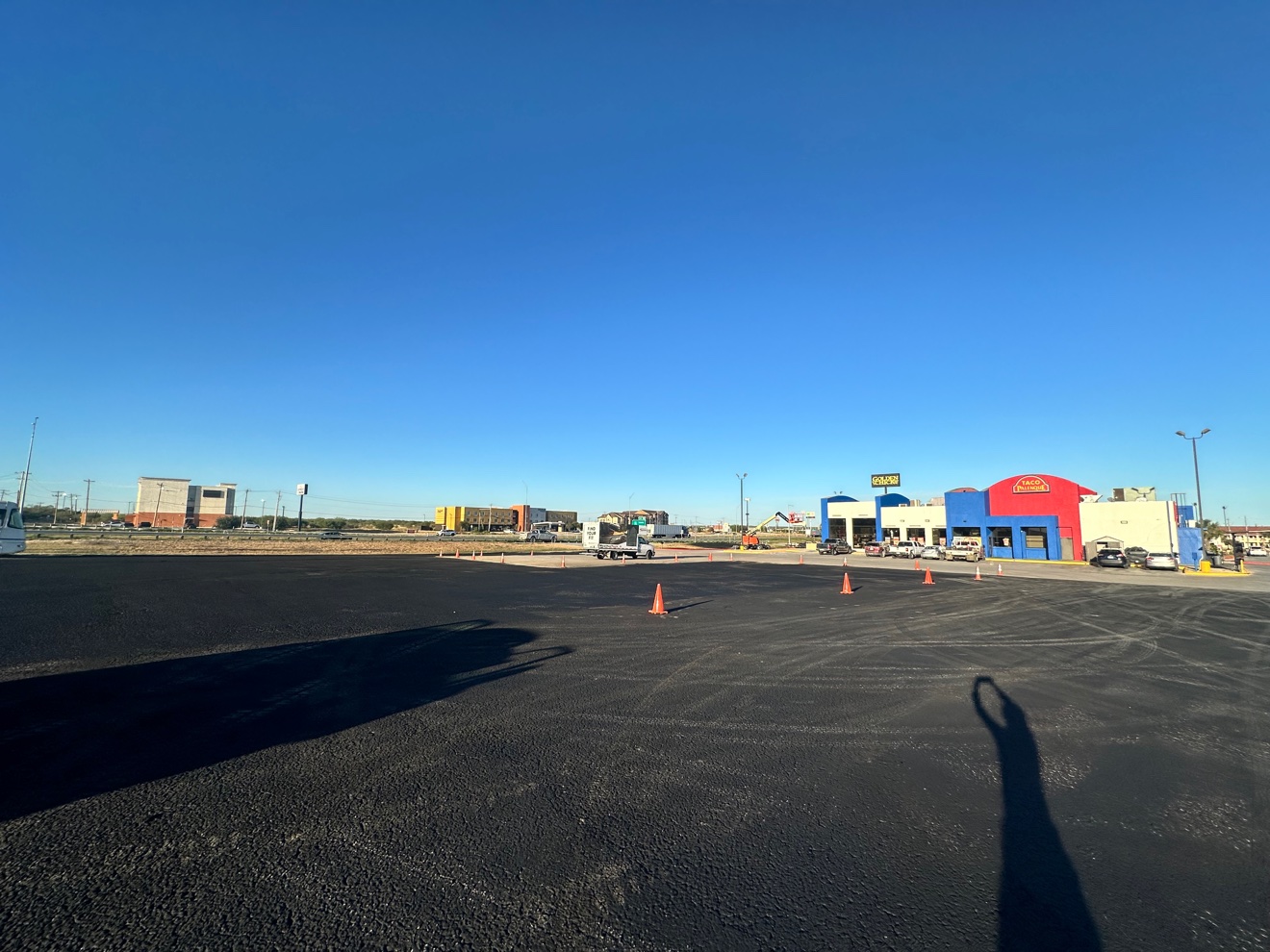 Freshly sealcoated asphalt parking lot at Taco Palenque