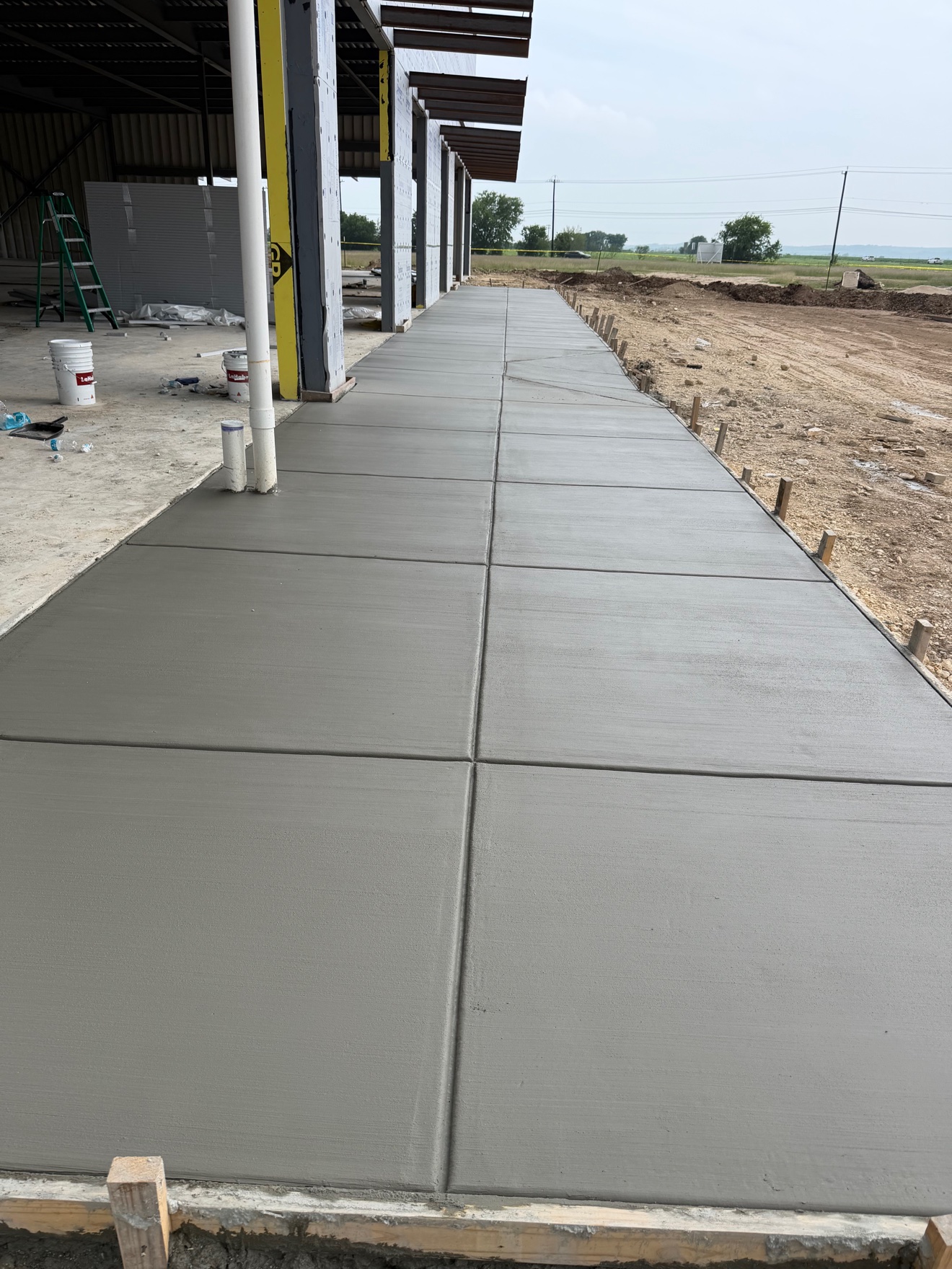 Freshly poured commercial concrete sidewalk viewed from the end