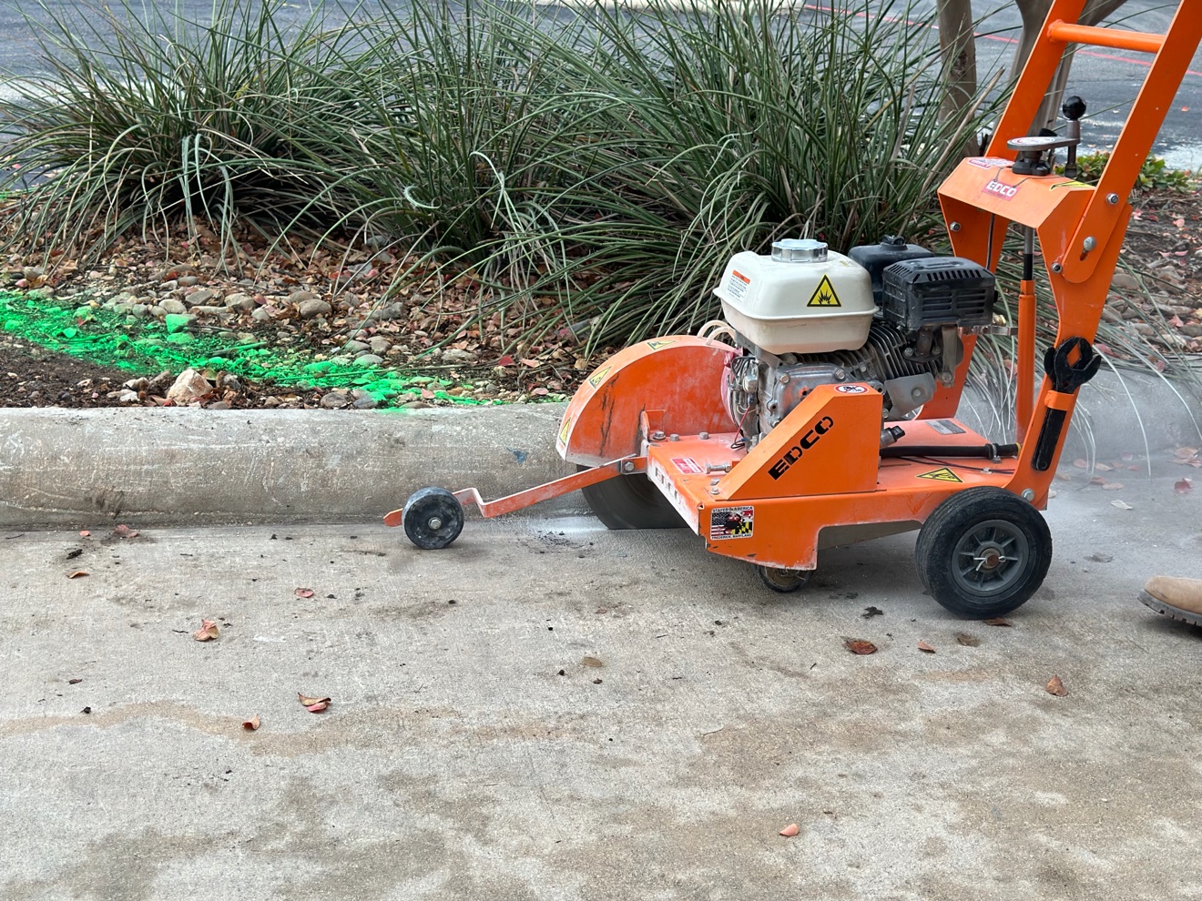 Concrete saw cutting the old curb on RaM'S Concrete's first job