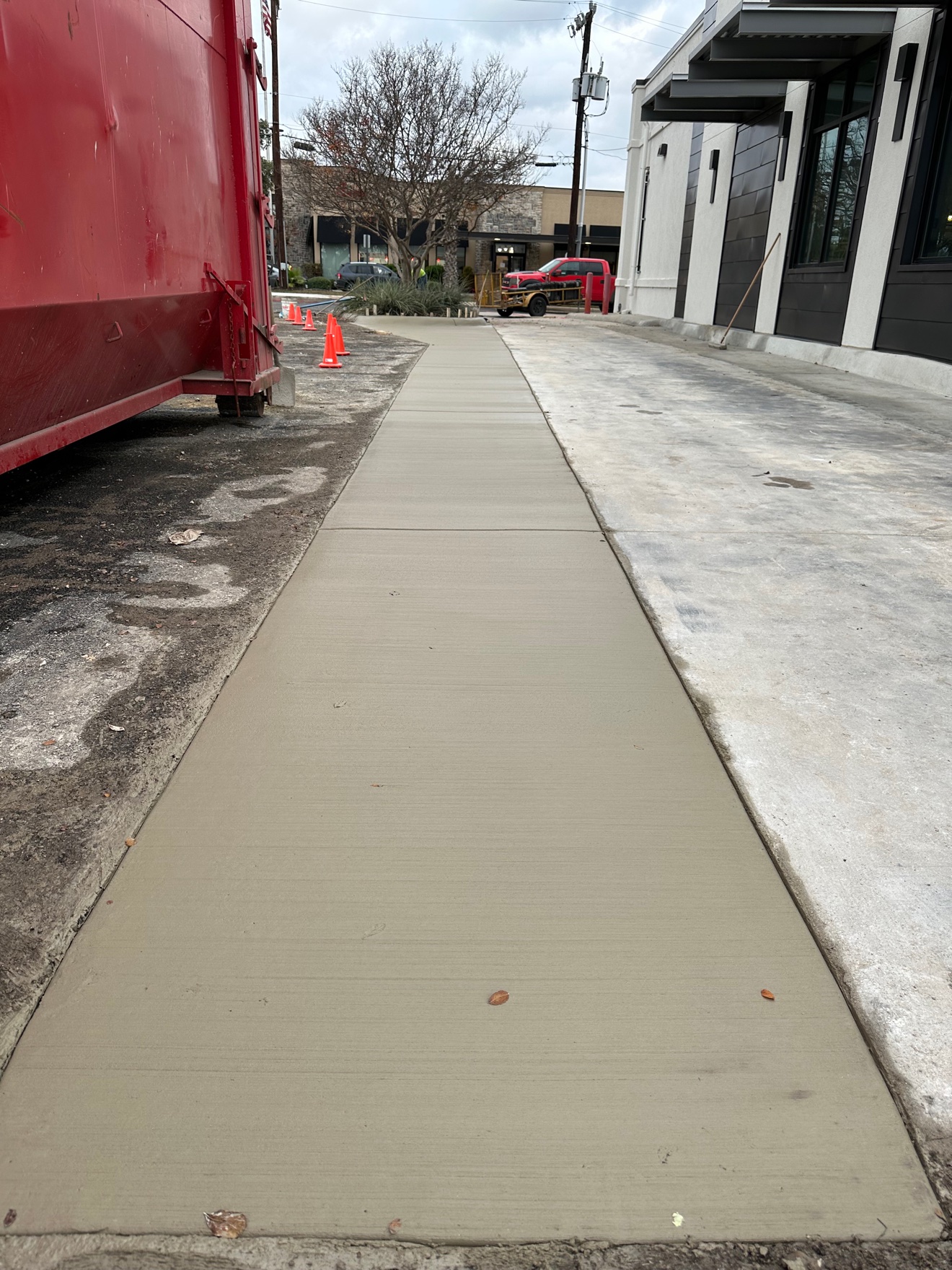 The new concrete sidewalk freshly poured and finished