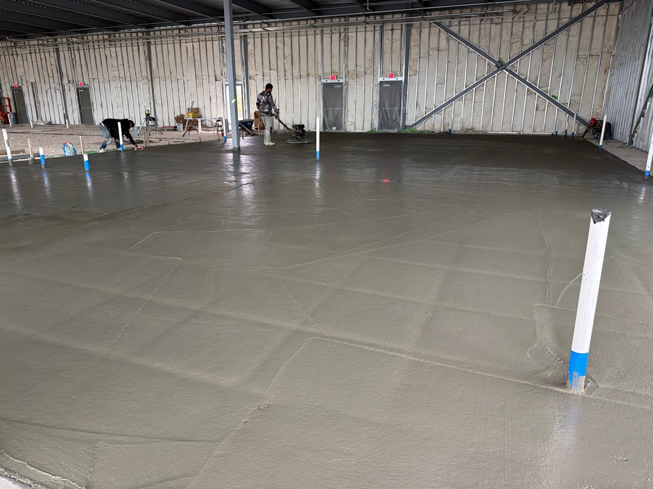 Power trowel finishing a large warehouse concrete floor